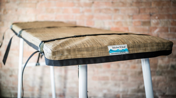 Padded cover for raft attached to river table.