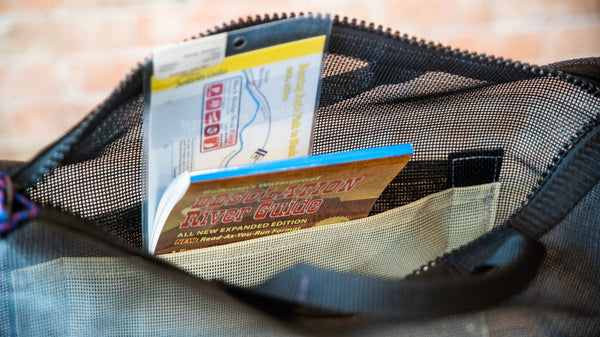The inside pocket of a boaters briefcase displaying how several different river maps can be stored