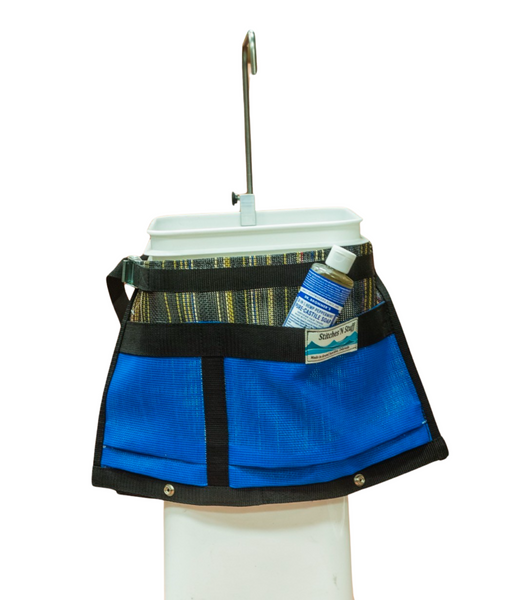 A blue mesh handwash station caddy attached to a Down River Equipment hand wash station containing a bottle of liquid soap.