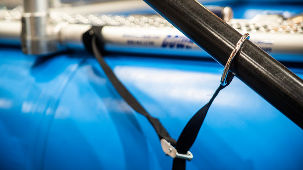 Close up of an oar leash showing the cam buckle attachment and stainless steel ring on a Hyside raft and Sawyer oar