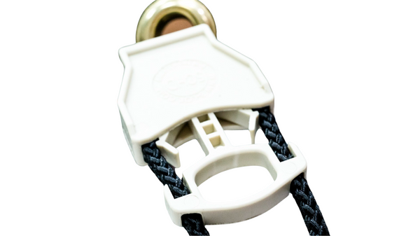 Close up of mesh round bottom bag showing stainless steel D-ring and cinch closure. 