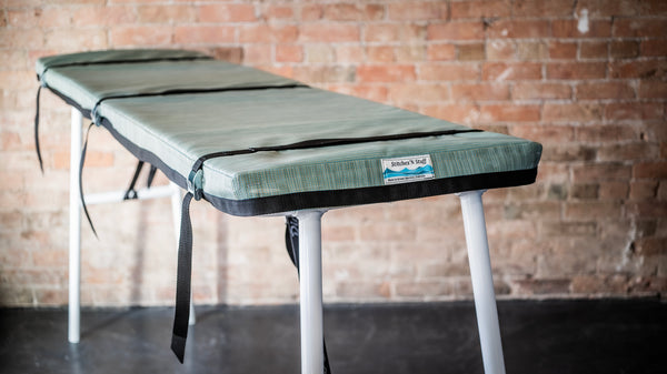 Padded cover for raft attached to river table.