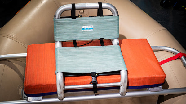 Green cover for raft captains seat on a raft frame and tan raft. 