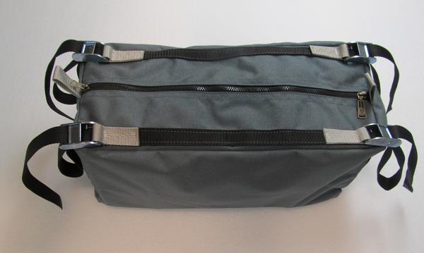 A grey cargo bag with black raft frame attachment straps, a full-length top zipper, and a carry handle on a white background.